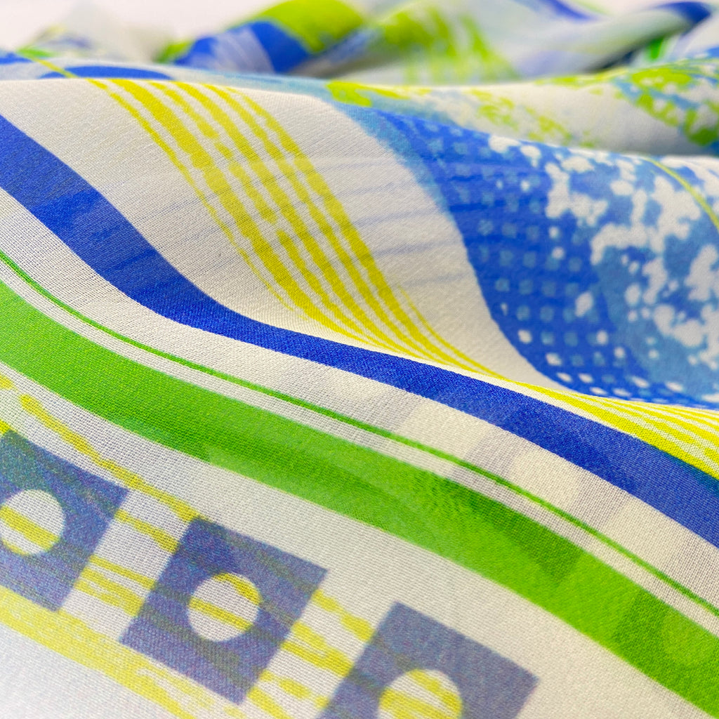 Close-up of colorful fabric with blue, green, and yellow patterns.